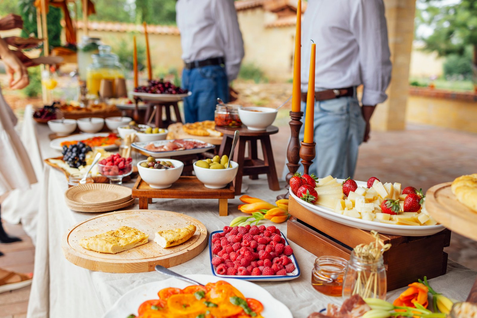 Outdoor summer wedding gathering with guests seated at tables