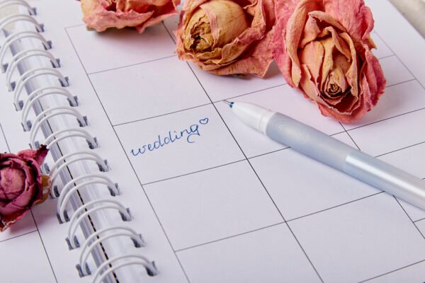 Wedding planning checklist with calendar, rings and flowers