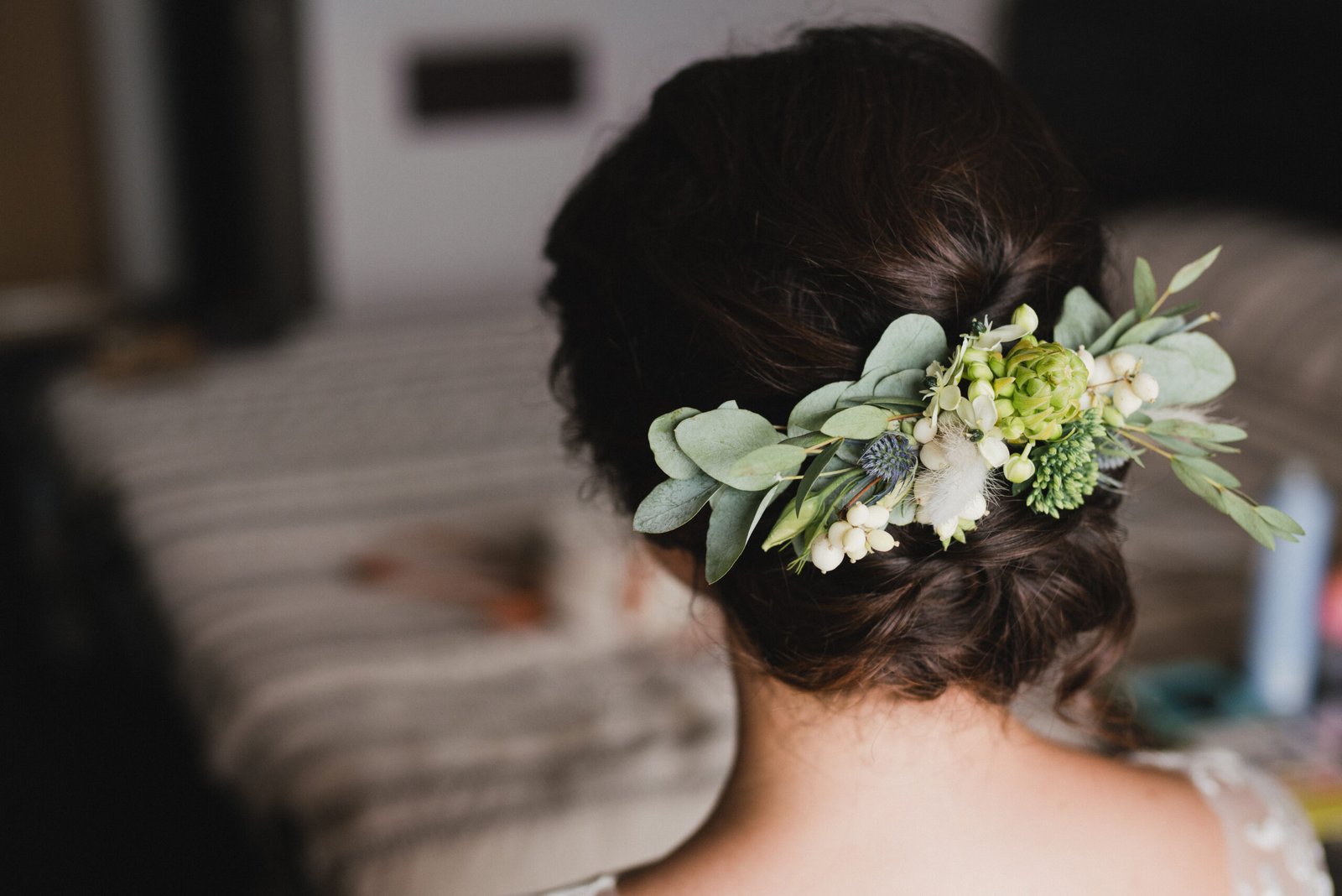 Close-up of a bride's wedding hairstyle with a flower accent