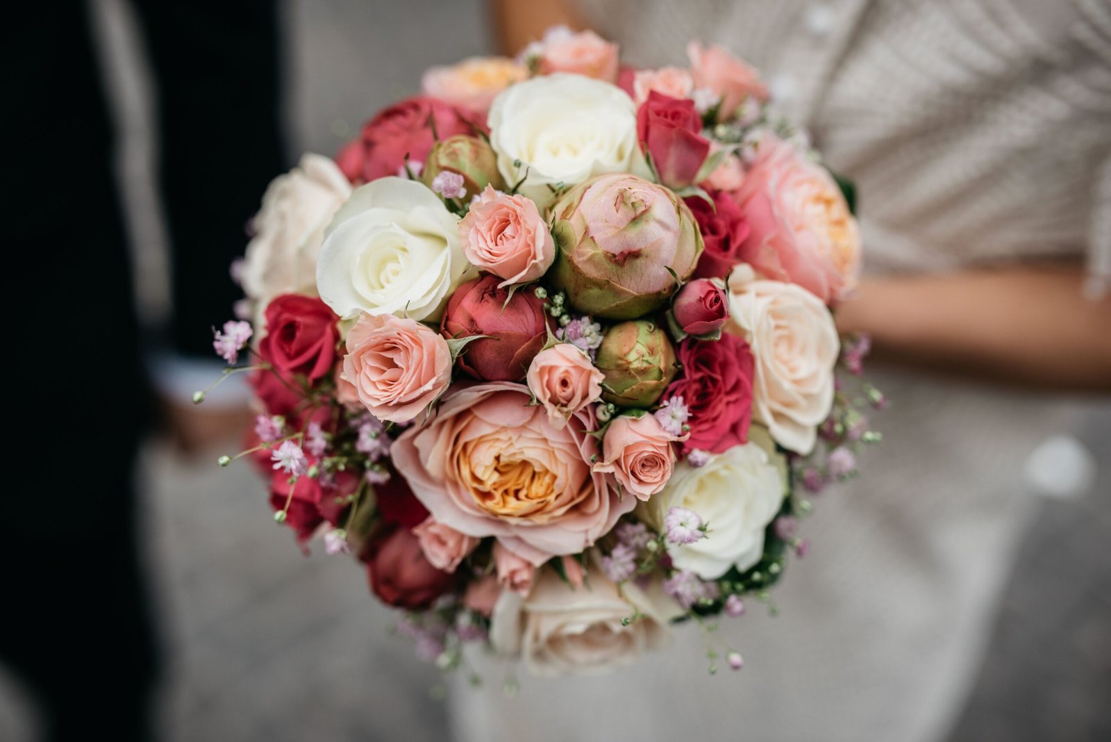 Elegant bride holding a colorful wedding bouquet