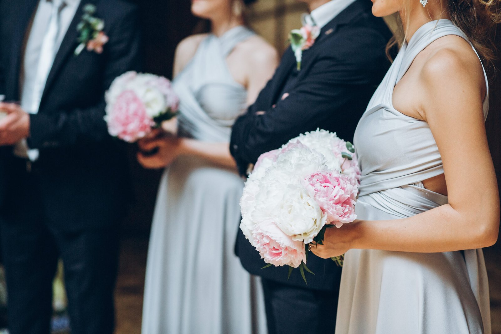 Bridesmaids and groomsmen posing outdoors at a wedding