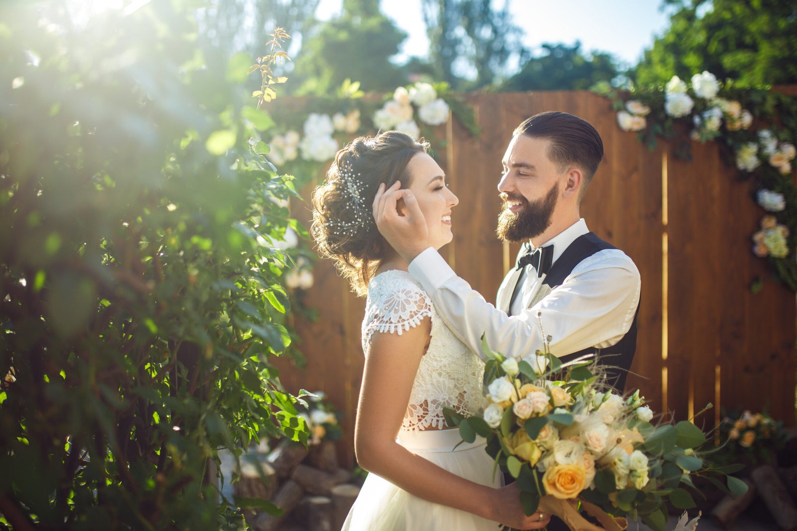 Newlyweds smiling together outdoors in the sun