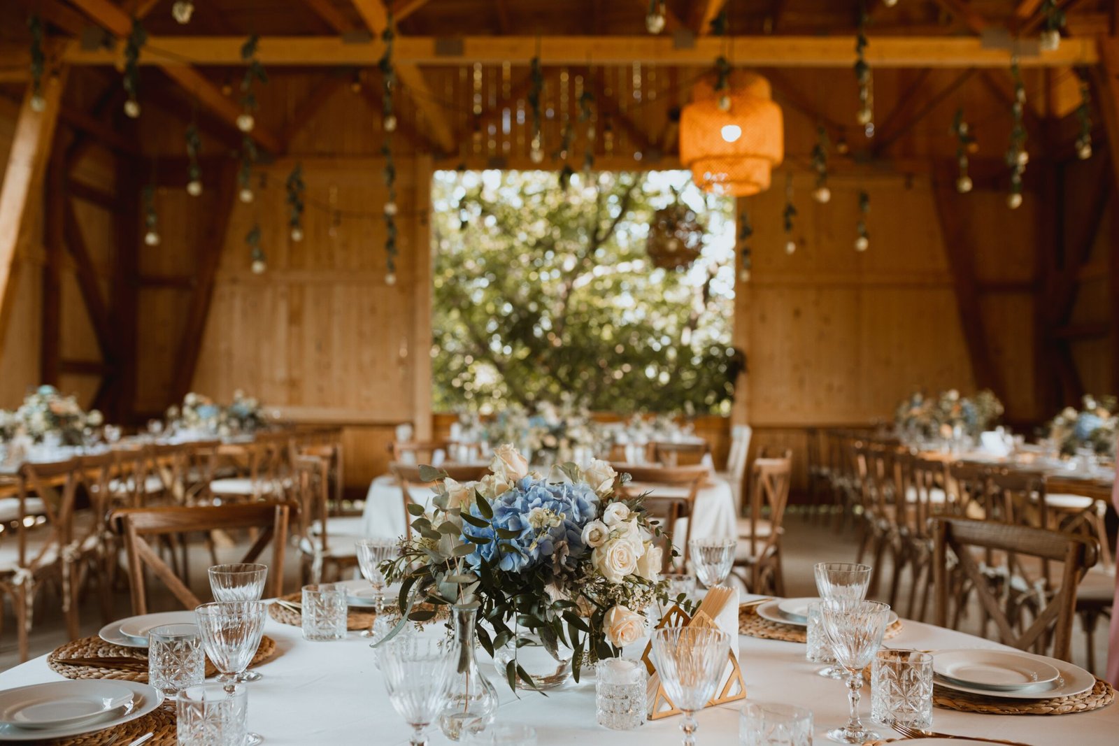 Barn wedding reception set with tables and décor in the Duluth area