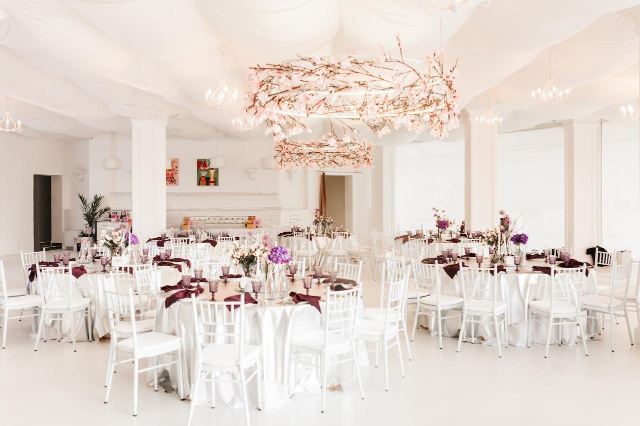 Bright white ballroom set with round tables for a Duluth wedding reception